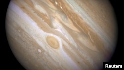 FILE - The planet Jupiter is shown with one of its moons, Ganymede (bottom), in this NASA handout taken April 9, 2007, and obtained by Reuters, March 12, 2015.