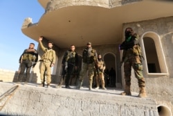 Turkish-backed Syrian rebels enter the own of Saraqeb, in Idlib province, Syria, Feb. 27, 2020.
