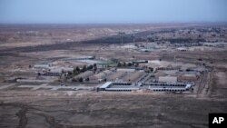 FILE - An aerial photo taken from a helicopter shows al-Asad Air Base in the western Anbar desert, Iraq, Dec. 29, 2019. It was one of the sites where U.S. forces have been attacked with drones or rockets in October 2023. 