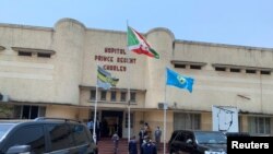 FILE - Security officials keep watch outside the Prince Regent Charles Hospital as Burundi's Prime Minister Alain-Guillaume Bunyoni visits the victims of an explosion, in Bujumbura, Burundi, September 21, 2021.