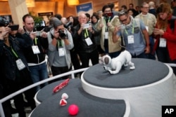 FILE - The Aibo robot dog is on display at the Sony booth after a news conference at CES International in Las Vegas, Jan. 8, 2018.