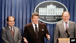 FILE - In this June 17, 1986 file photo, President Ronald Reagan announces the nomination of Antonin Scalia, left, to the Supreme Court. William Rehnquist is at right.