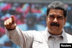 Venezuela's President Nicolas Maduro greets supporters during a campaign rally in Charallave, Venezuela, May 15, 2018.