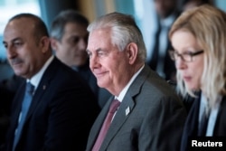 Secretary of State Rex Tillerson, center, sits with other diplomats before a meeting on Syria in Bonn, Germany, Feb.17, 2017.