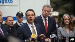 Mayor Bill de Blasio looks on as Gov. Andrew Cuomo delivers remarks during a news conference after NYPD personnel removed an explosive device from Time Warner Center, Oct. 24, 2018, in New York.