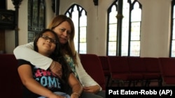 Nury Chavarria, 43, poses with her 9-year-old daughter, Hayley inside Iglesia De Dios Pentecostal church in New Haven, Conn., on Monday, July 24, 2017