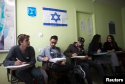 FILE - Newly arrived immigrants from France, all of whom are from Paris, study Hebrew at Ulpan Etzion, the original residential school and absorption center, in Jerusalem, Jan. 20, 2015.