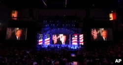 A video message from President Donald Trump is played on the stage during a hurricanes relief concert in College Station, Texas, Oct. 21, 2017.