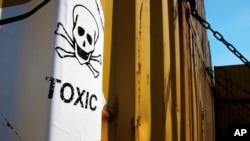 FILE - A sticker on containers carrying Syria's dangerous chemical weapons, on the Danish cargo ship Ark Futura, in Cyprus coastal waters.