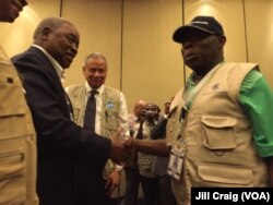 Former Nigerian President Olusegun Obasanj, right, head of Commonwealth Observers, greets former Zambian President Rupiah Banda after a news conference in Kampala, Feb. 20, 2016. Banda heads Electoral Institute for Sustainable Democracy in Africa (EISA) mission.
