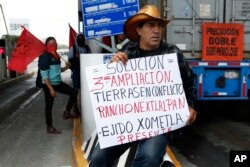FILE - Atenco residents protest the construction of the new Mexico City airport near their community, near Texcoco, Mexico, Oct. 12, 2018.