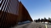 Mounted Border Patrol agents ride along a newly fortified border wall structure, Oct. 26, 2018, in Calexico, California. 