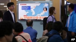 People watch a TV news program reporting North Korea's earthquake, at Seoul Railway Station in Seoul, South Korea, Saturday, Sept. 23, 2017.