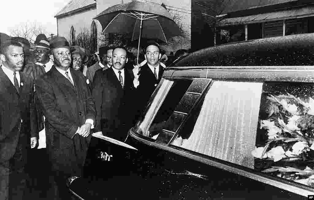 Martin Luther King, Jr. and associates lead a procession behind the casket of Jimmy Lee Jackson during a funeral service at Marion, Alabama, March 1, 1965.