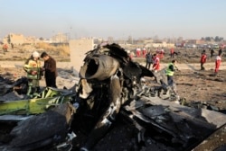 FILE - Debris is seen from a downed Ukrainian plane as authorities work at the scene, in Shahedshahr, southwest of the capital Tehran, Iran, Jan. 8, 2020.