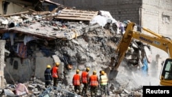 Emergency personnel work at the scene after a building collapsed in a residential area of Nairobi, Kenya, June 13, 2017.