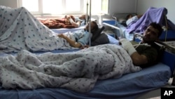 Injured men receive treatment at a hospital after a clash between Taliban and security forces in Kunduz province, Afghanistan, April 13, 2019.