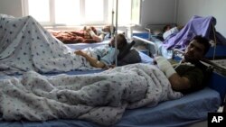 Injured men receive treatment at a hospital after a clash between Taliban and security forces in Kunduz province, Afghanistan, April 13, 2019.
