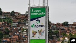 Sign for the first Iranian supermarket that is set to open its doors in Latin America stands near a poor neighborhood in Caracas, Venezuela, July 29, 2020.