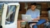 FILE - In this 2018 photo, Danny Fenster works out of his van that he made into a home/office in Detroit, Michigan.