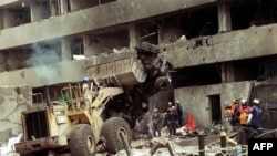 photo taken on August 8, 1998 shows police workers removing the remains of the car-bomb used to destroy the US embassy in Nairobi, that killed 280 Kenyans and 12 Americans. Kenya and Tanzania on August 7, 2018 will commemorate the 20th anniversary of the attacks against the US embassies in Nairobi and Dar es Salaam, which marked the emergency of terrorist group al-Qaeda on the international scene and changed the relationship of people to their personal security. In mid-morning of August 7, 1998, an important explosion devastated the US embassy in central Nairobi. The attack was followed a few minutes later by another blast in Dar es Salaam. Both attacks killed 224 people and injured 5,000, mostly Africans. 