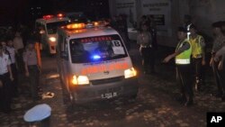 Ambulances carrying the body of drug convicts Dutch national Ang Kiem Soe, front, and Brazilian national Marco Moreira, leave from Nusakambangan island where their executions were held, at Wijayapura port in Cilacap, Central Java, Indonesia, Jan. 18, 2015