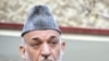 Afghan President Hamid Karzai talks with journalists after visiting victims at the Emergency Hospital in Kabul, December 7, 2011.