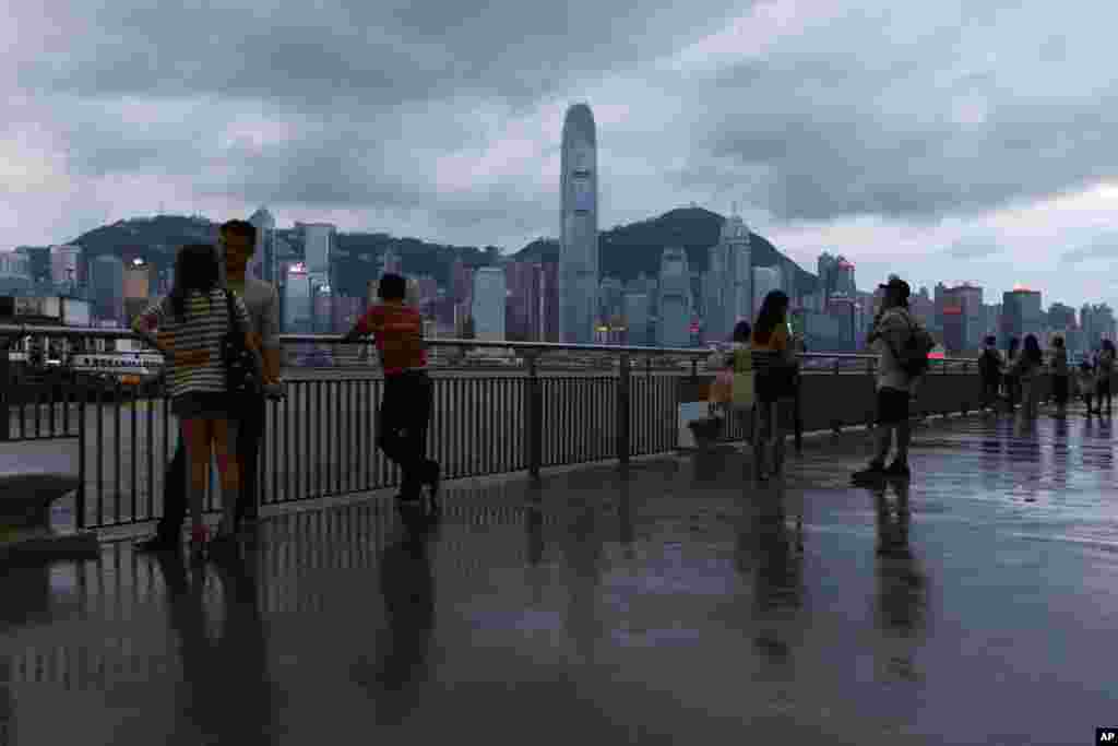 People gather at the waterfront of Hong Kong's Victoria Harbor, July 17, 2014.