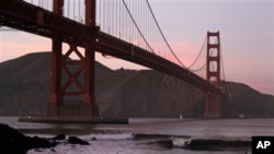 Surfers catch waves late in the day under the Golden Gate Bridge in San Francisco, Wednesday, Jan. 19, 2011. (AP Photo/Eric Risberg)