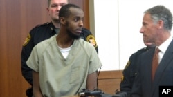 FILE - Abdirahman Sheik Mohamud, left, speaks with his attorney, Sam Shamansky, during a hearing to set bond on charges of money laundering and providing support for terrorism in Columbus, Ohio, Feb. 25, 2015.