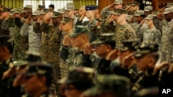 U.S. and Philippine troops salute during the opening ceremony of their joint military exercise dubbed "Balikatan 2015" at Camp Aguinaldo at suburban Quezon city, northeast of Manila, Philippines, April 20, 2015.