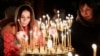 People light candles during a religious service at a church in Kyiv, Feb. 23, 2014. 