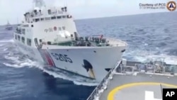 In this image taken from handout video provided by the Philippine coast guard, a Chinese coast guard ship with bow number 5205, right, collides with Philippine coast guard vessel BRP Teresa Magbanua near the Sabina Shoal at the disputed South China Sea on Aug. 31, 2024. 