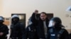 Spanish rapper Pablo Hasel reacts as he is detained by riot police inside the University of Lleida, after he was sentenced to jail time on charges including insulting the monarchy and glorifying terrorism, in Lleida, Spain, Feb. 16, 2021. 