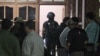FILE - Indonesian police officers of Special Detachment 88 anti-terror unit search for evidence following a raid on a house used as a hideout by suspected militants' in Mojokerto, East Java, Indonesia, Dec. 19, 2015.