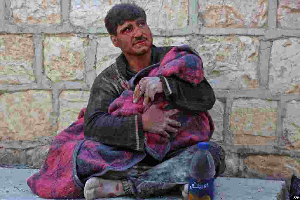 A Syrian man weeps as he cradles the body of his daughter who was killed following reported shelling in the town of Khan Sheikhun in the southern countryside of the rebel-held Idlib province. The government's bombardment near Khan Sheikhun, in Idlib province, also killed two civilians, raising the civilian death toll to 42 since February 9, according to the Britain-based Syrian Observatory for Human Rights.