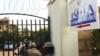 Ugandan police officers stand by the entrance of the Esella Country Hotel after police raided a gay rights workshop which was taking place in the hotel in Kampala, June 18, 2012.