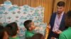 FILE - Colgate global ambassador Michael Phelps speaks to students in Celebration of Campus Sustainability Month at Alain L. Locke Magnet School, Oct. 19, 2017, in New York.