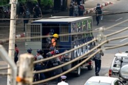 FILE - Police detain protesters as they crack down on demonstrations against the military coup in Yangon, Myanmar, Feb. 27, 2021.
