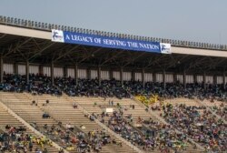 Members of the public sit in the stands during the state funeral for former president Robert Mugabe, at the National Sports Stadium, in the capital Harare, Zimbabwe, Sept. 14, 2019.
