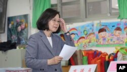Taiwanese President Tsai Ing-wen waits to cast her ballot at a polling station, Saturday, Nov. 24, 2018, in Taipei, Taiwan. 