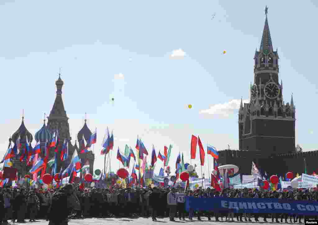 People walk with flags and banners at Red Square during a May Day rally in Moscow, Russia, May 1, 2016.