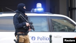 FILE - A Belgian special forces police officer stands guard outside a courthouse as Paris attacks suspect Salah Abdelslam remains in police custody, in Brussels, Belgium, April 7, 2016. 
