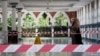 A woman wearing a protective mask walks at a mosque following the outbreak of coronavirus, in Kuala Lumpur, Malaysia March 16, 2020. REUTERS/Lim Huey Teng