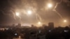Israeli forces' flares light up the night sky over Gaza City on July 29, 2014.