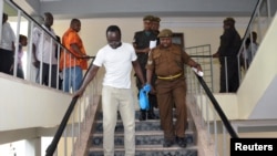 Tanzanian investigative journalist Erick Kabendera leaves after he appeared at the Kisutu residents magistrate court in Dar es Salaam, Tanzania, Sept. 12, 2019.