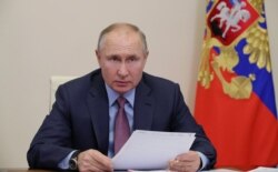 FILE - Russian President Vladimir Putin chairs a meeting via a video conference call at Novo-Ogaryovo state residence outside Moscow, Russia, Feb. 10, 2021.