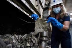 FILE - Lyn Riggins, WSSC Water spokesperson, holds up a wipe that was collected along with other debris at a pumping station in Washington.