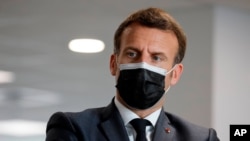French President Emmanuel Macron visits a call center of the French Social security insurance dedicated to Covid-19 vaccinations, March 29, 2021 in Creteil, outside Paris.