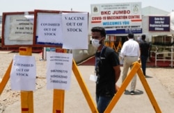 Notices about the shortage of Covishield, a coronavirus vaccine manufactured by Serum Institute of India, are seen outside a COVID-19 vaccination center in Mumbai, India, April 20, 2021.